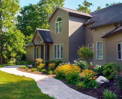 multi-colored flowers and evergreen foundation plants