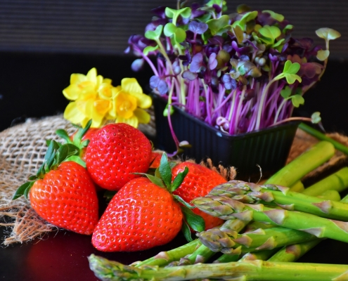 edible plants with strawberries, asparagus and sprouts