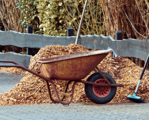 gardening tools, wheelbarrow and mulch