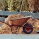gardening tools, wheelbarrow and mulch